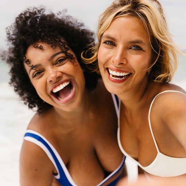 Smiling woman sitting on a couch.