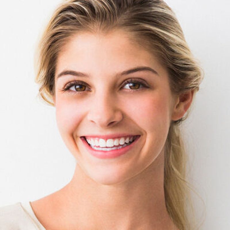 Smiling model with blonde hair against white background