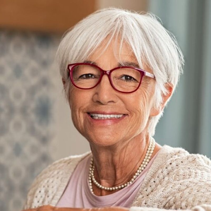 Smiling older woman with short gray hair.