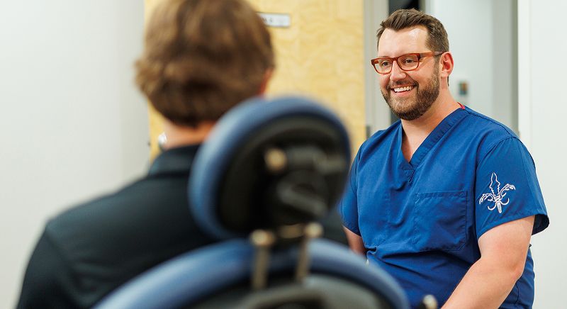 Smiling doctor consulting with patient indoors.