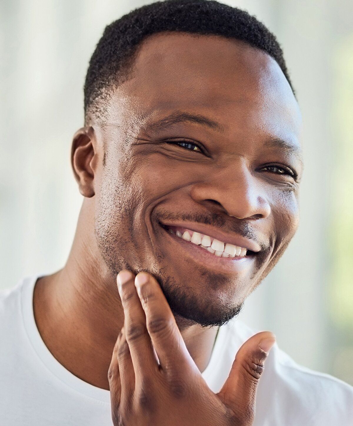 Smiling woman with long, light hair and earrings.