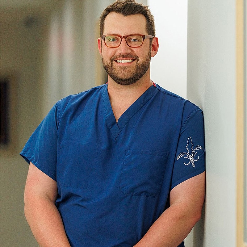Dental professionals performing an oral procedure.