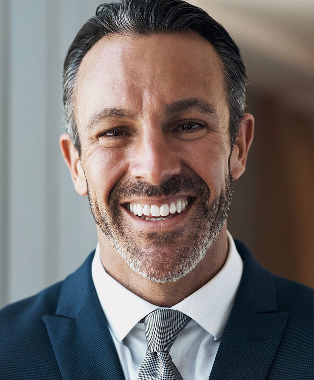Smiling man in a suit and tie.