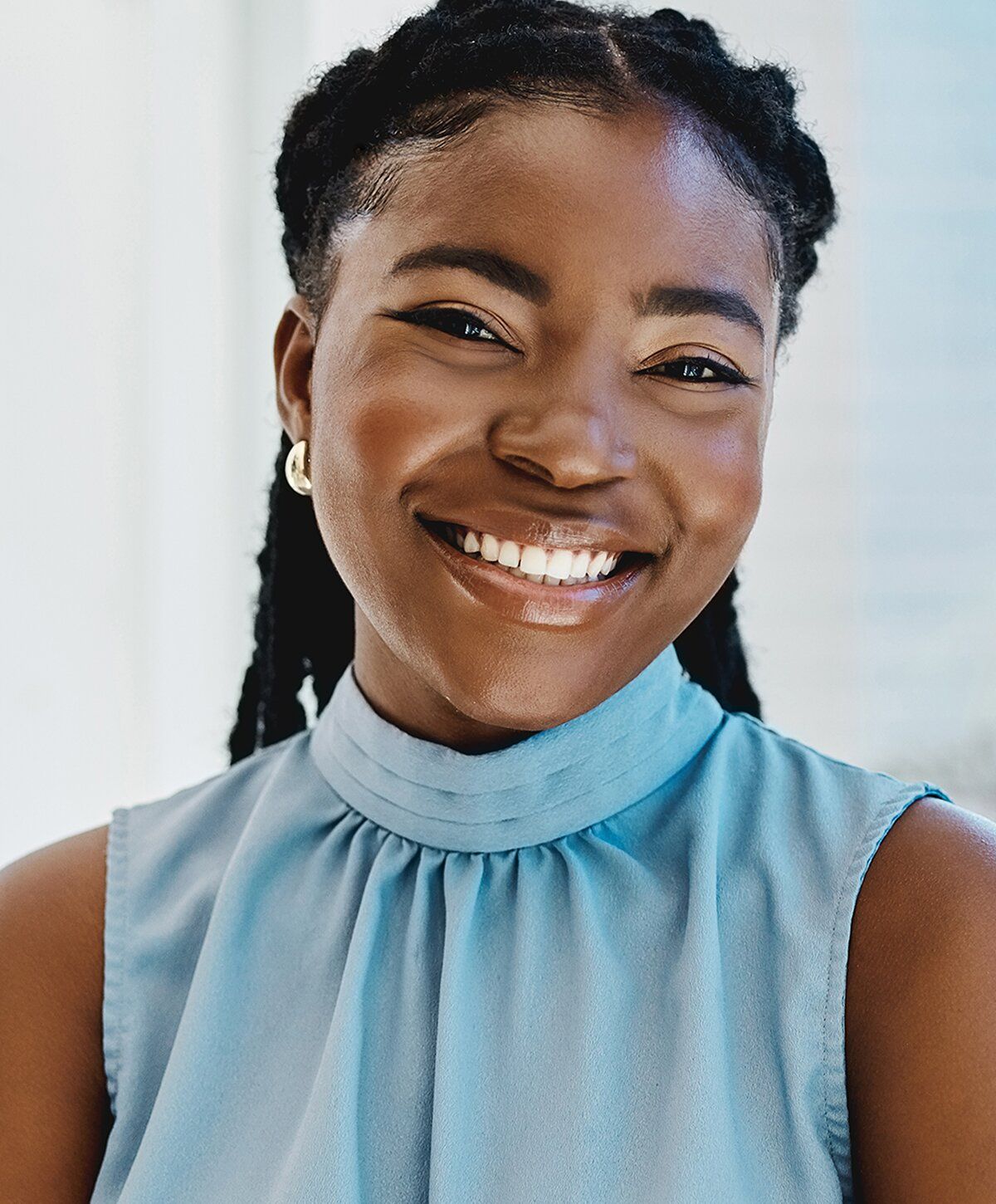 Smiling woman wearing a blue blouse.