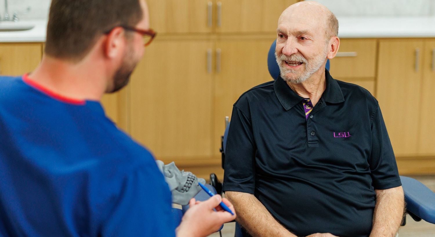 Patient interacting with healthcare professional in clinic.