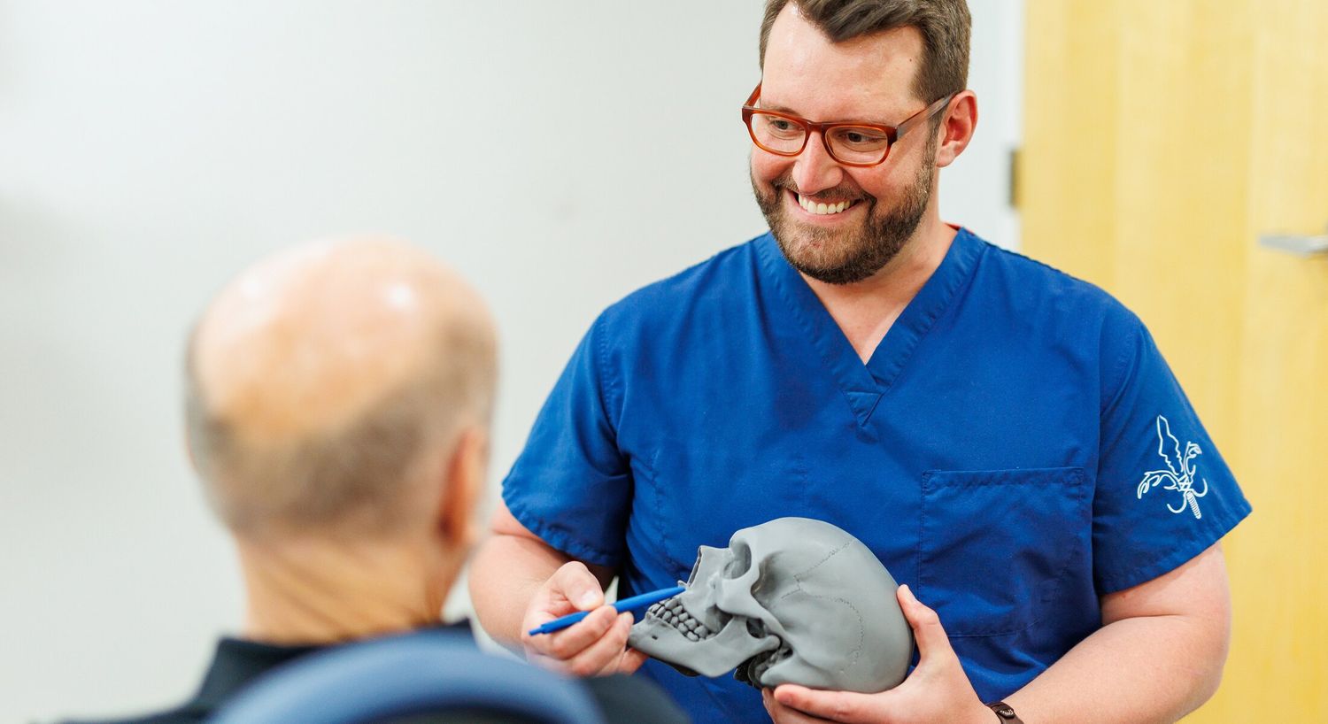 Doctor explains skull anatomy to patient.
