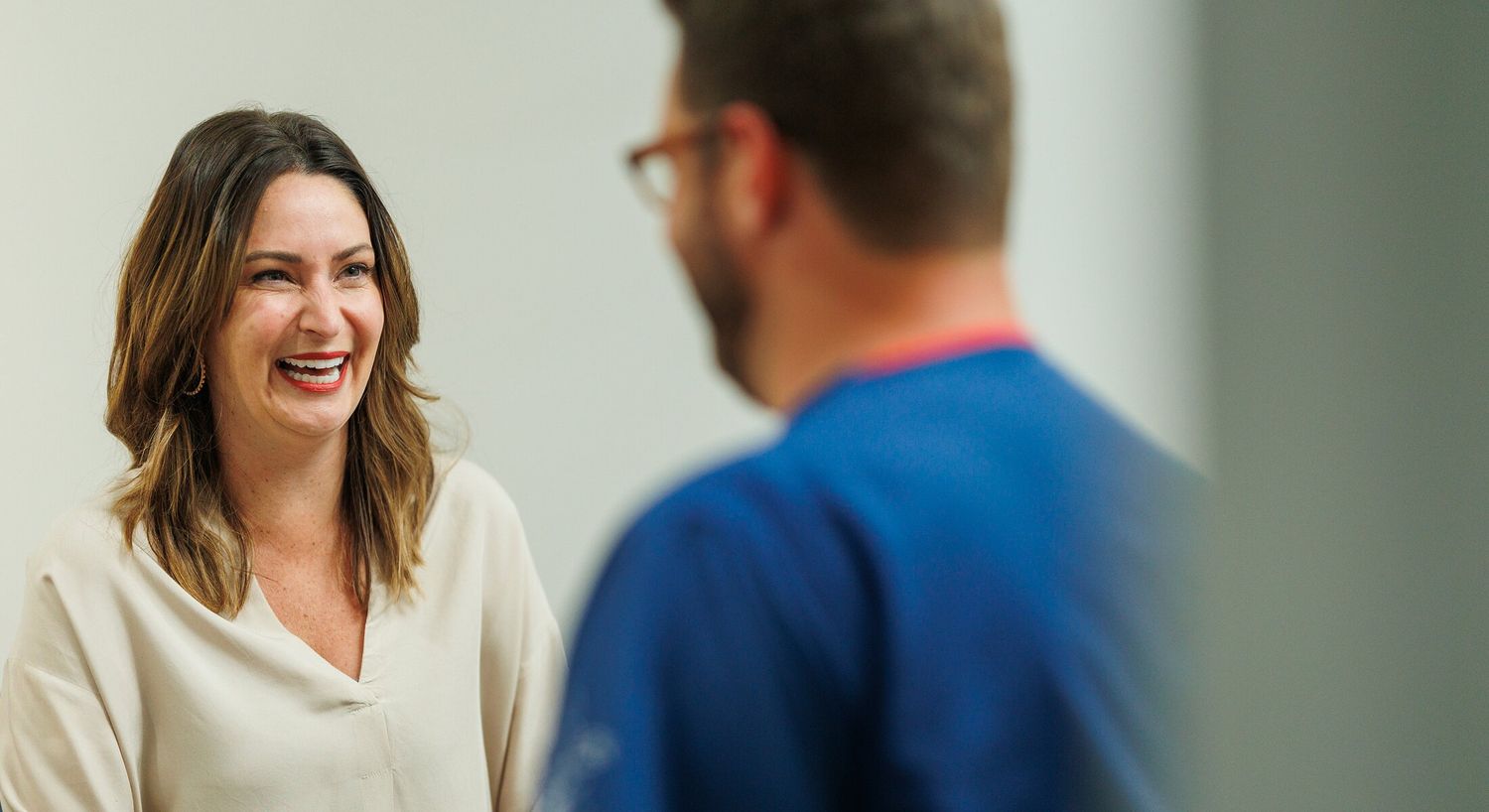 Smiling woman engaged in conversation.